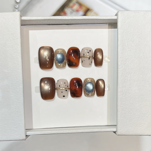 Hand-painted bronze cat-eye press-on nails with tortoiseshell accents