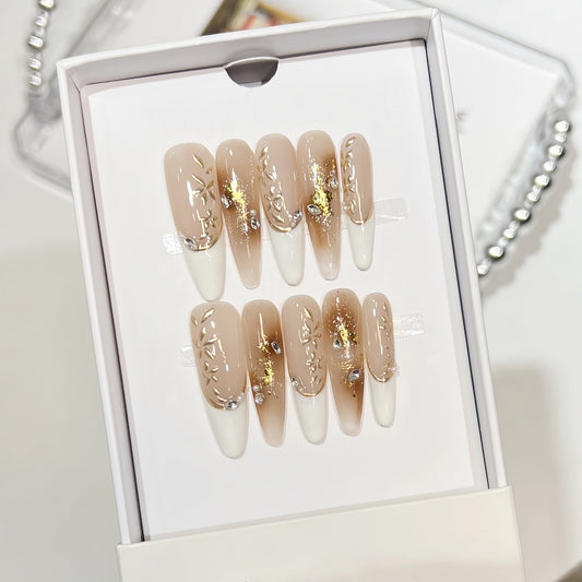 Hand-painted French tip press-on nails with gold foil and rhinestone accents