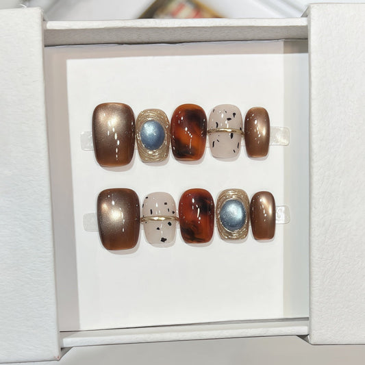 Hand-painted bronze cat-eye press-on nails with tortoiseshell accents