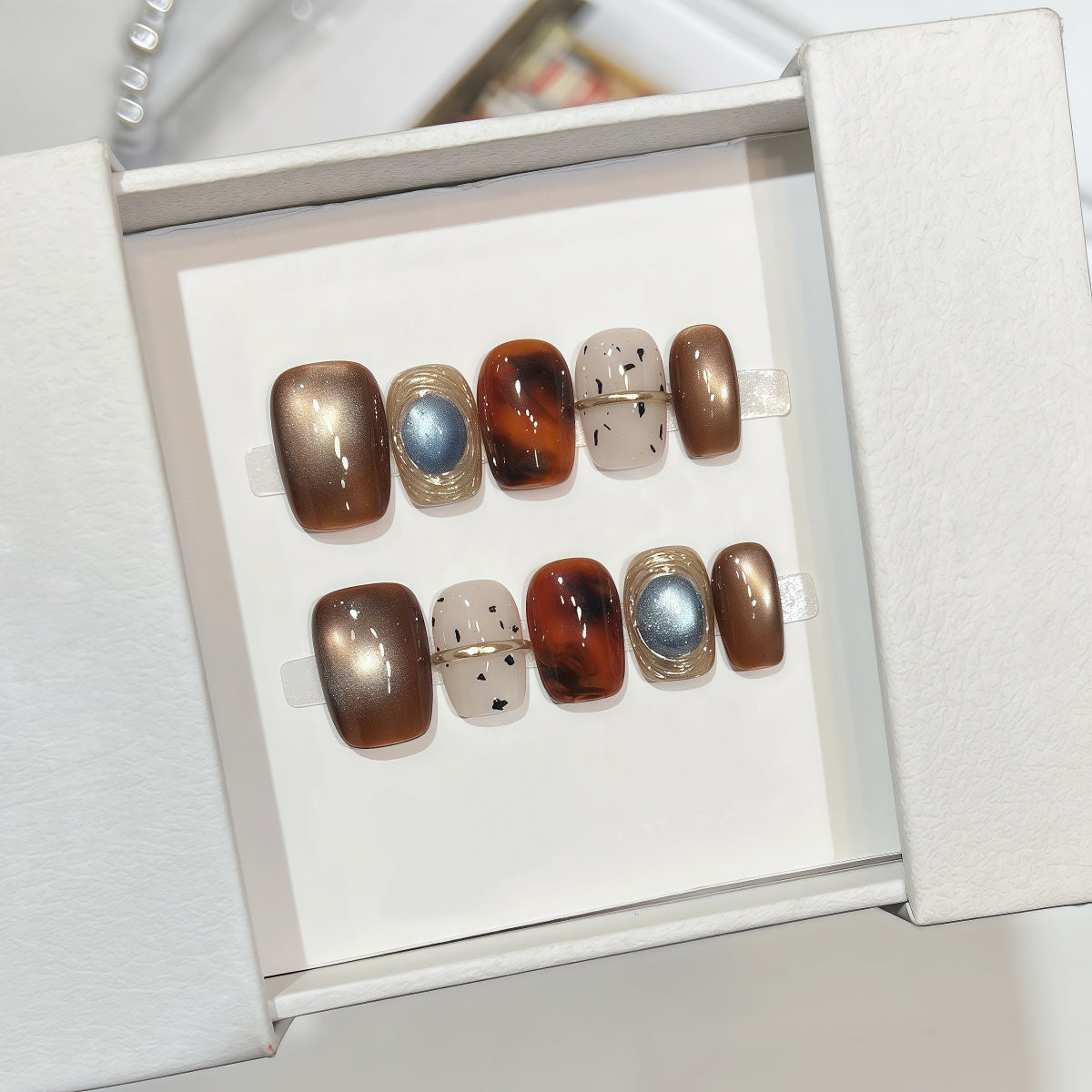 Hand-painted bronze cat-eye press-on nails with tortoiseshell accents