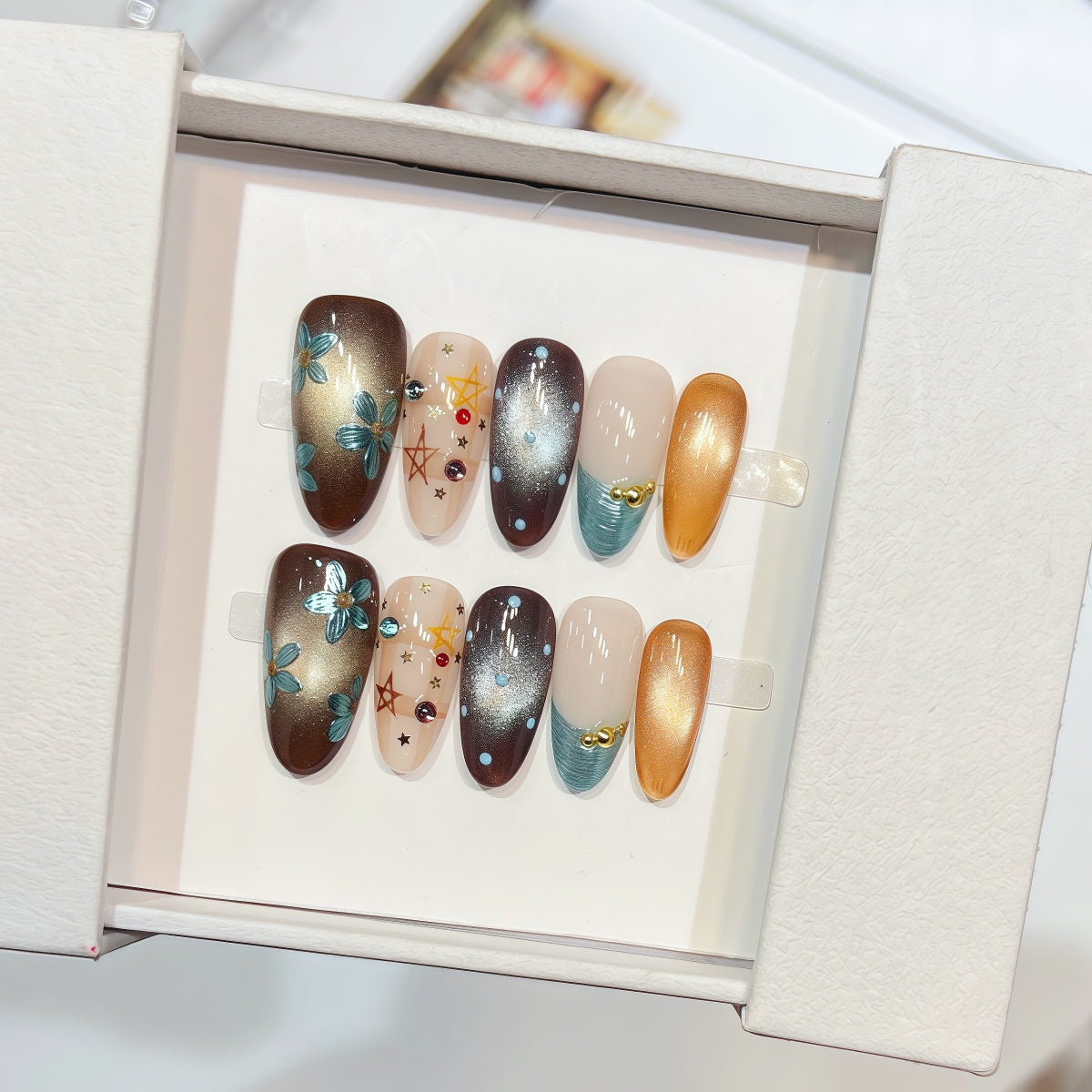 hand-painted reusable almond press-on nails with gold and turquoise floral design