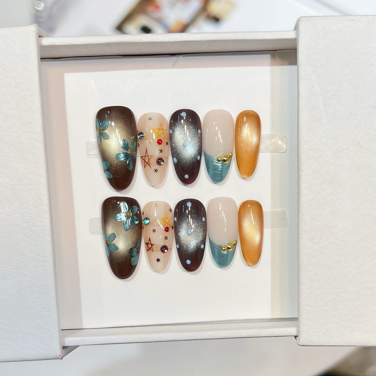 hand-painted reusable almond press-on nails with gold and turquoise floral design