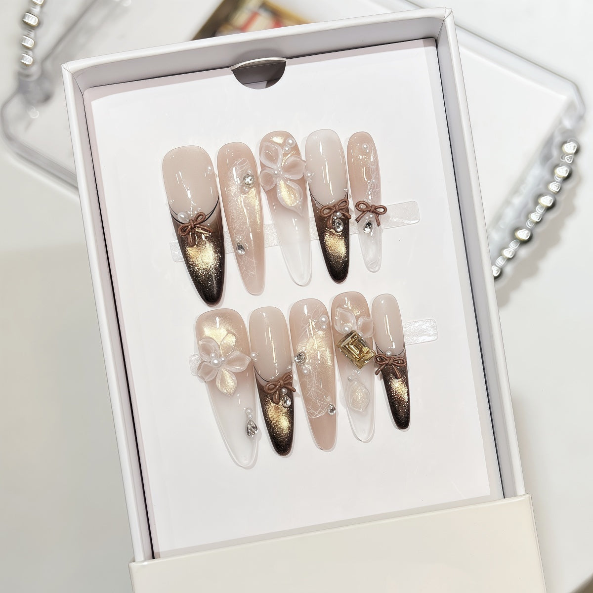 Extra-long nude and gold cat eye french tips handmade press-on nails with 3D bow and floral accents