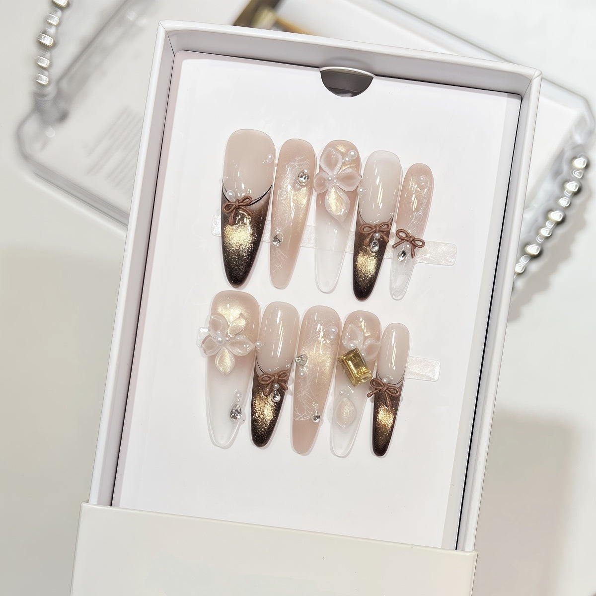 Extra-long nude and gold cat eye french tips handmade press-on nails with 3D bow and floral accents