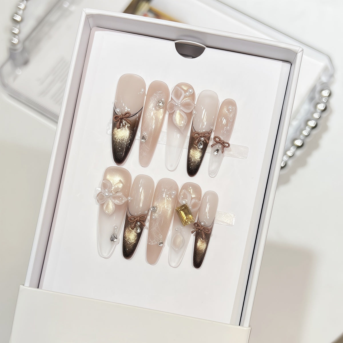 Extra-long nude and gold cat eye french tips handmade press-on nails with 3D bow and floral accents