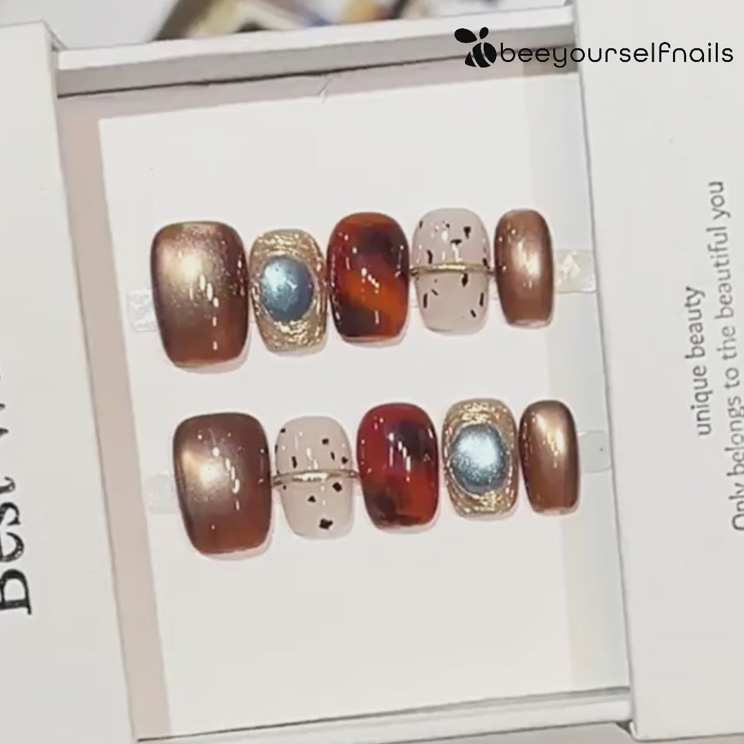 Hand-painted bronze cat-eye press-on nails with tortoiseshell accents