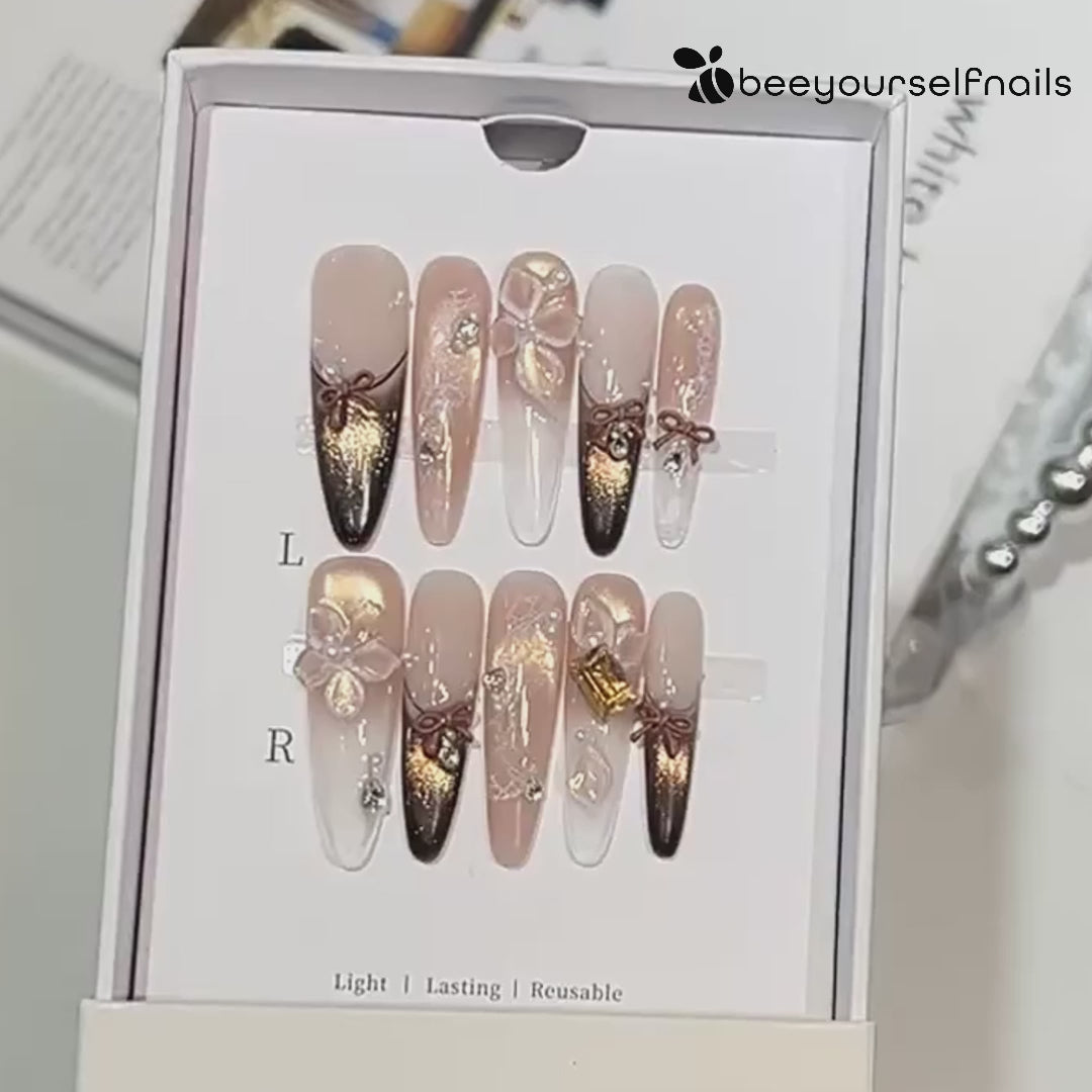 Extra-long nude and gold cat eye french tips handmade press-on nails with 3D bow and floral accents